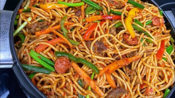 Jollof Spaghetti served with Plantain and chopped chicken